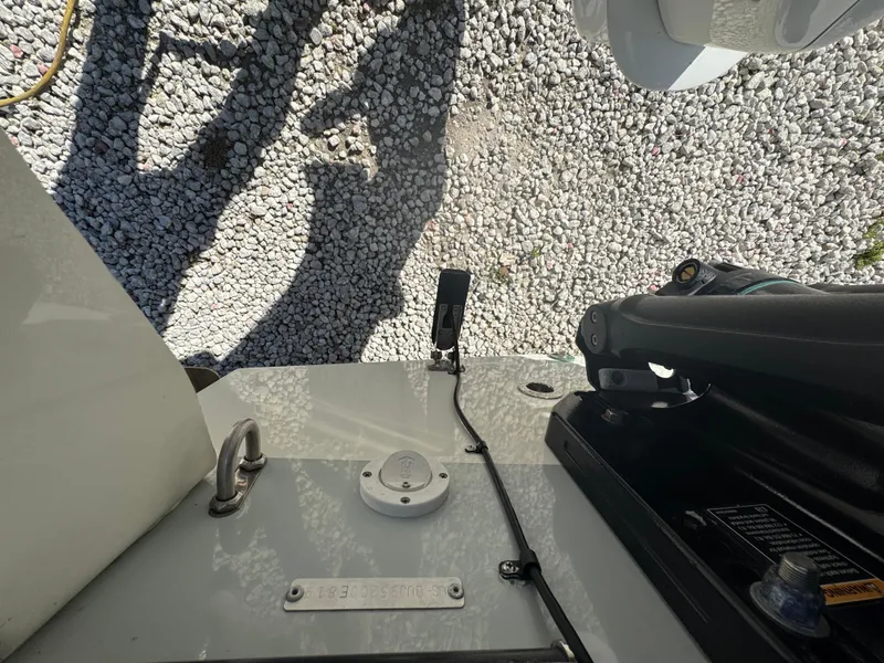 Slide: The Image of Boat deck of a 2019 Mako 214C with equipment and gravel background. - 26