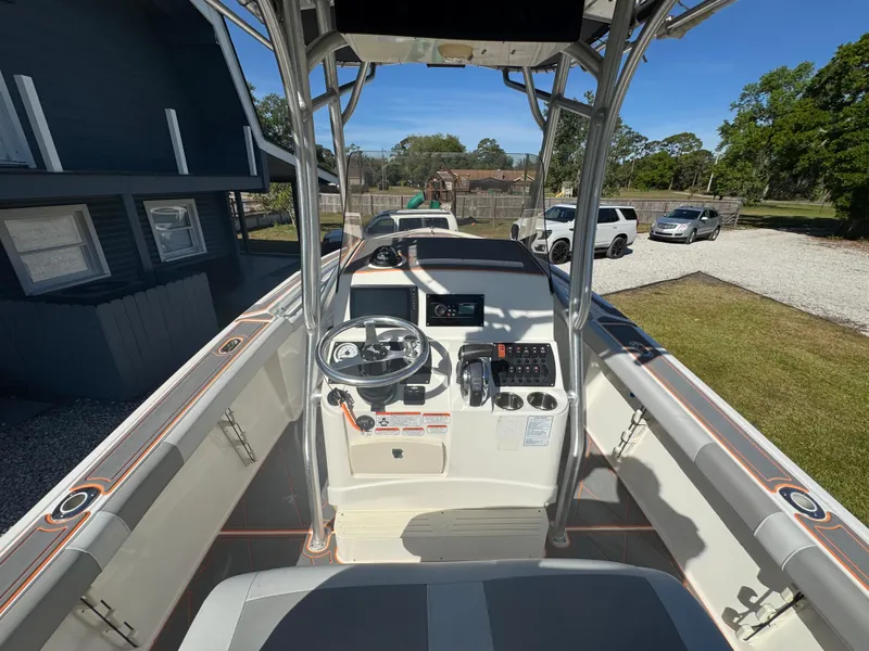 Slide: The Image of Center console of a 2019 Mako 214C boat with steering wheel and controls. - 34