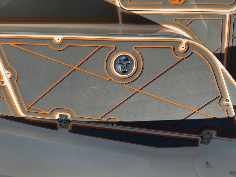 Slide: The Image of Close-up of a 2019 Mako 214C boat deck with orange trim and textured surface. - 43