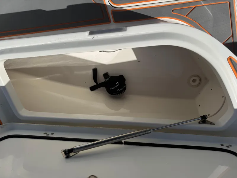 Slide: The Image of Open storage compartment on a 2019 Mako 214C boat. - 44