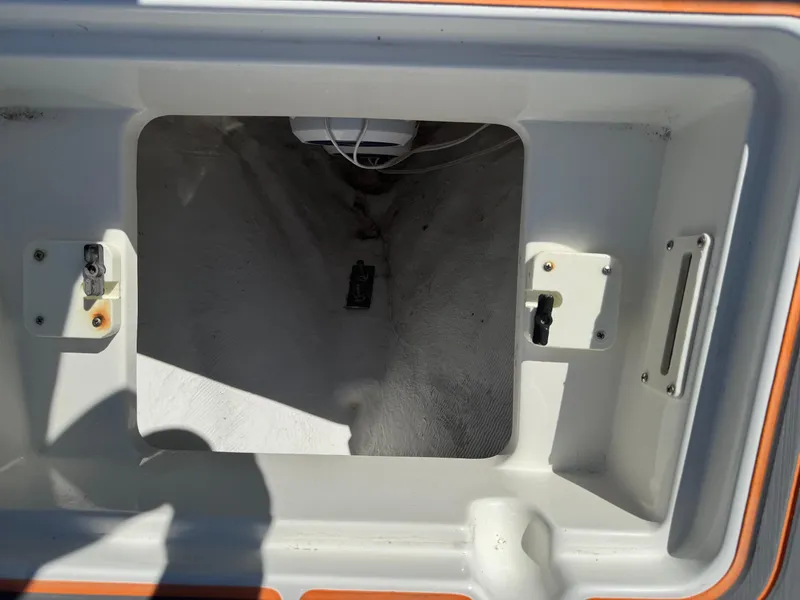 Slide: The Image of Open storage compartment in a 2019 Mako 214C boat. - 48
