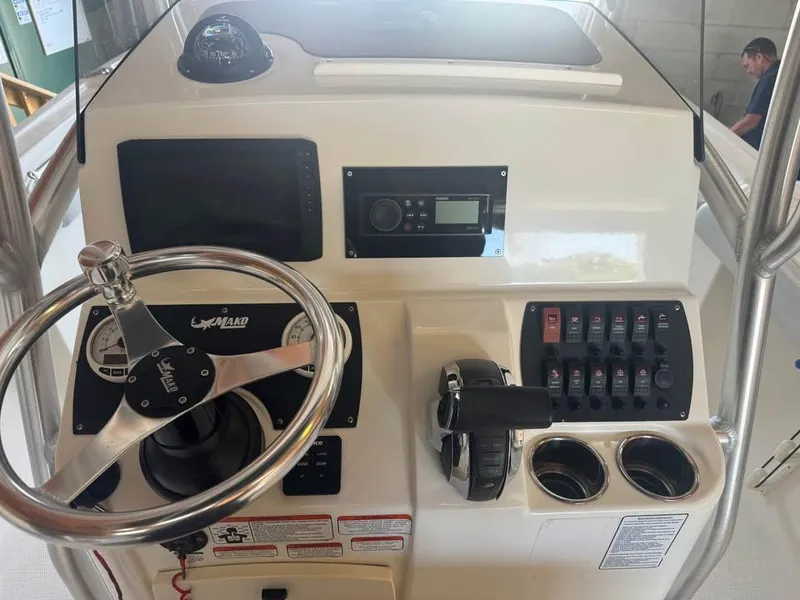 Slide: The Image of 2019 Mako 214C boat dashboard with steering wheel and control panel. - 5