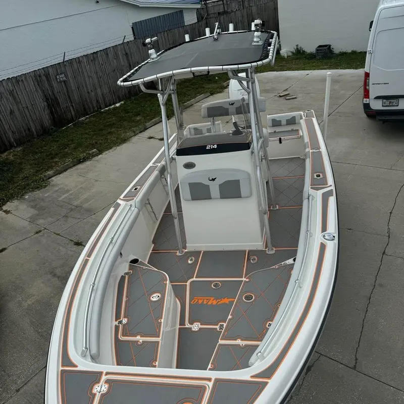 Slide: The Image of 2019 Mako 214C boat with T-top, parked in driveway. - 6
