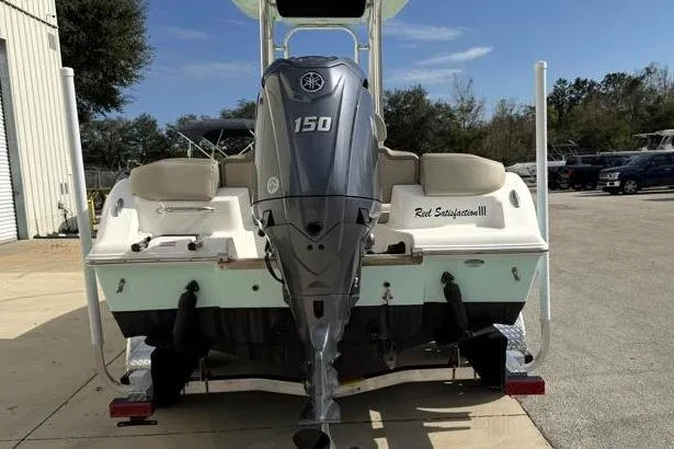 Slide: The Image of 2024 Key West 203 FS boat with Yamaha 150 engine, parked outdoors. - 10