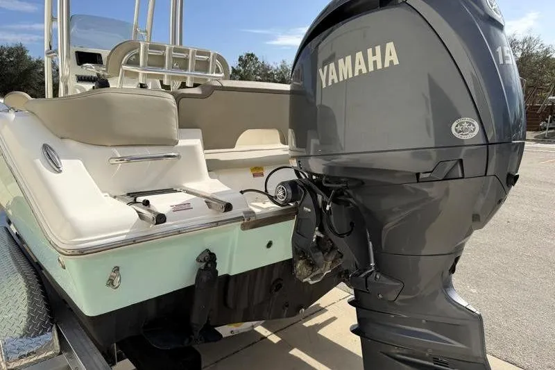 Slide: The Image of 2024 Key West 203 FS boat with Yamaha 150 engine, parked on a trailer. - 11