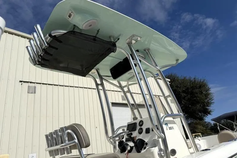 Slide: The Image of 2024 Key West 203 FS boat with T-top and rod holders under a clear sky. - 14