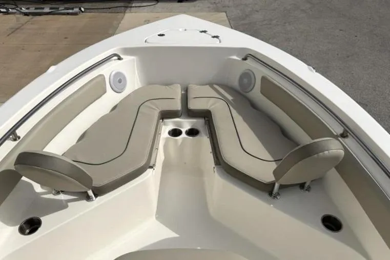 Slide: The Image of 2024 Key West 203 FS boat interior with cushioned seating and cup holders. - 18