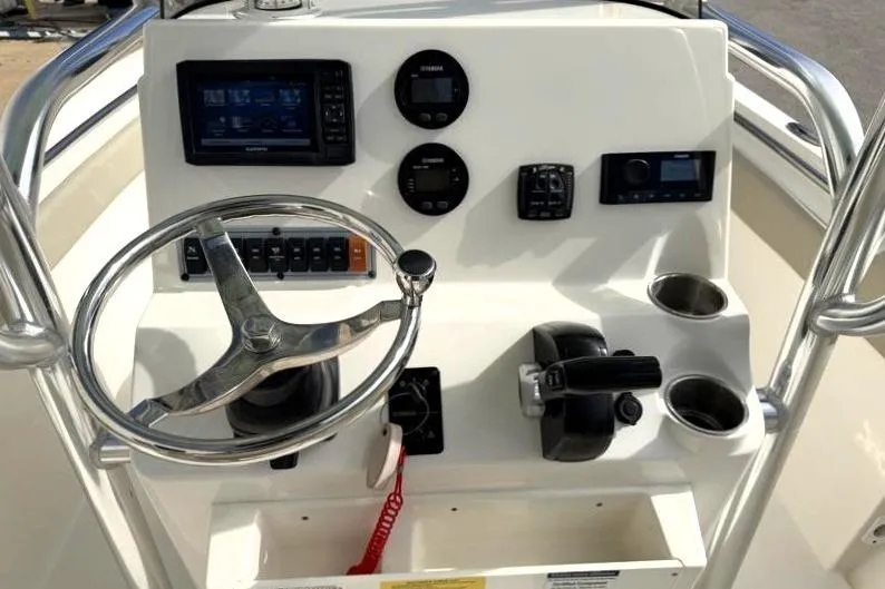 Slide: The Image of 2024 Key West 203 FS boat console with steering wheel and navigation controls. - 27