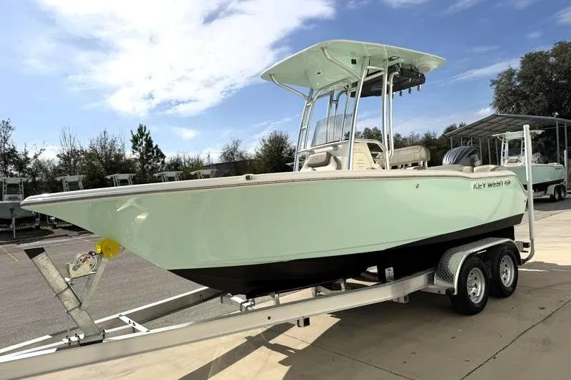 Slide: The Image of 2024 Key West 203 FS boat on trailer, parked outdoors under a clear sky. - 3