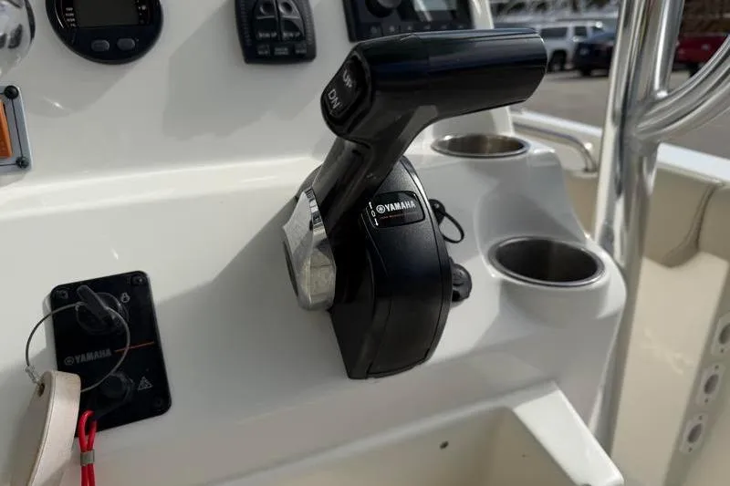 Slide: The Image of 2024 Key West 203 FS boat console with Yamaha throttle control and cup holders. - 30