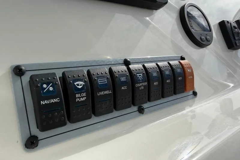 Slide: The Image of Control panel of 2024 Key West 203 FS boat with labeled switches and gauges. - 31