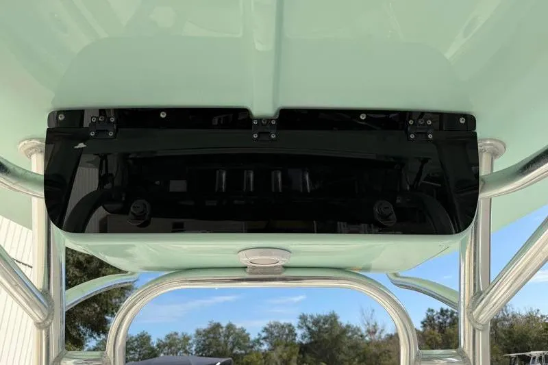 Slide: The Image of 2024 Key West 203 FS boat T-top with rod holders and clear sky background. - 32