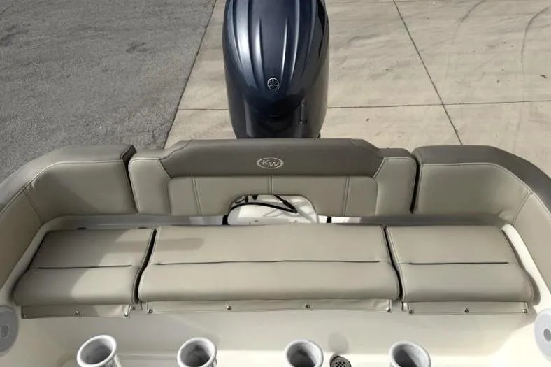 Slide: The Image of 2024 Key West 203 FS boat with cushioned seating and outboard motor. - 35