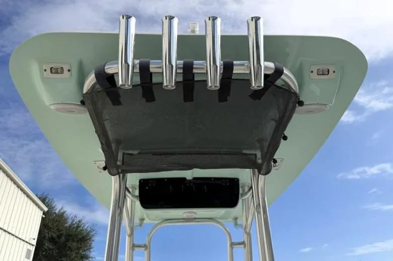 Slide: The Image of 2024 Key West 203 FS boat T-top with rod holders against blue sky. - 37