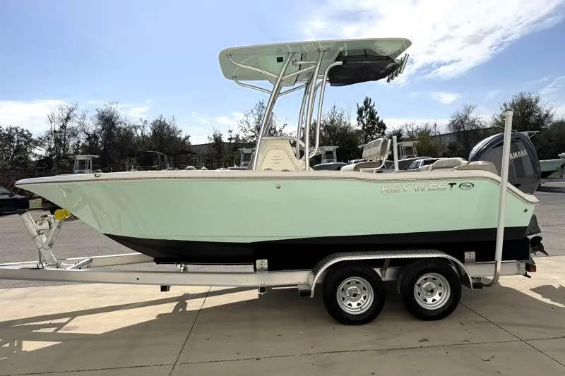 Slide: The Image of 2024 Key West 203 FS boat on trailer, side view, outdoors. - 4
