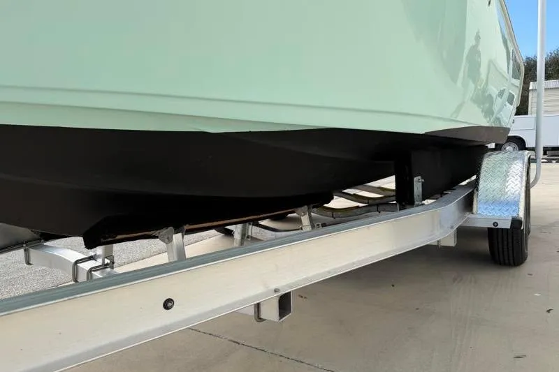 Slide: The Image of 2024 Key West 203 FS boat on trailer, close-up view of hull and wheels. - 41