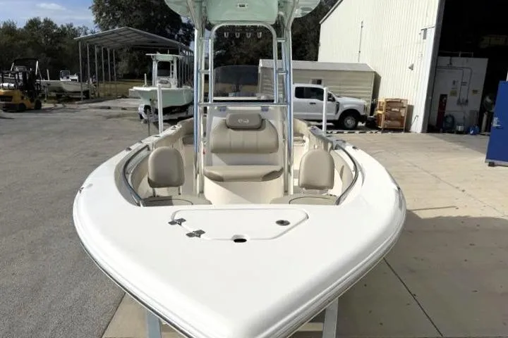 Slide: The Image of 2024 Key West 203 FS boat, white exterior, docked near a warehouse. - 6