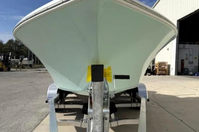 Slide: The Image of 2024 Key West 203 FS boat on trailer, parked outside a warehouse. - 7