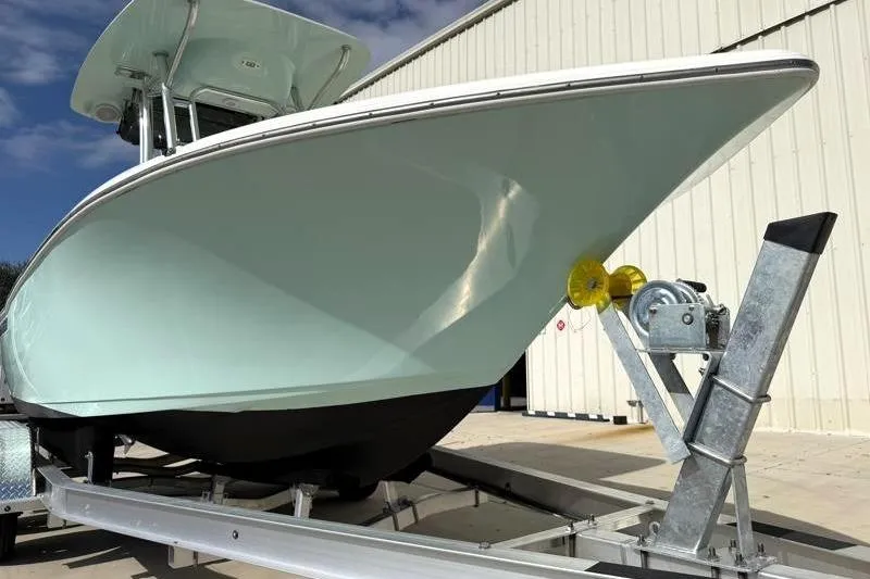 Slide: The Image of 2024 Key West 203 FS boat on trailer, parked outside a building. - 8