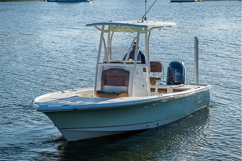 Slide: The Image of 2019 Sea Hunt BX 22 BR boat on calm water, featuring a sleek design and Yamaha engine. - 12
