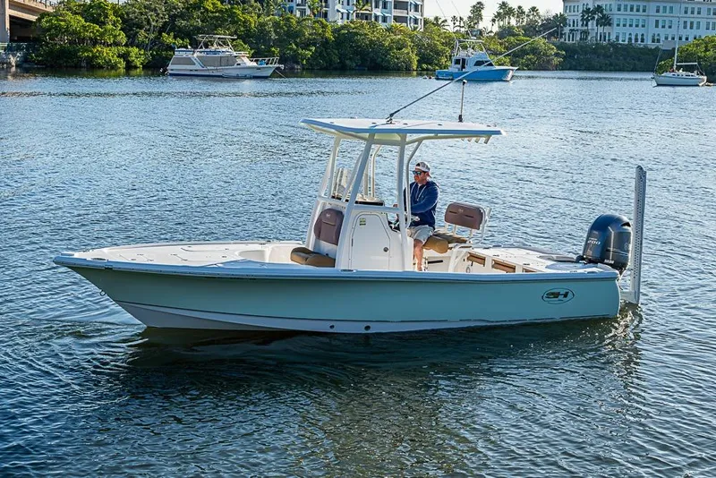 Slide: The Image of 2019 Sea Hunt BX 22 BR boat cruising on a calm waterway. - 14