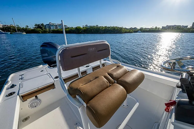 Slide: The Image of 2019 Sea Hunt BX 22 BR boat interior with cushioned seating, scenic water view. - 16