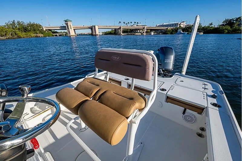 Slide: The Image of 2019 Sea Hunt BX 22 BR boat on water, near a bridge, with clear blue sky. - 17