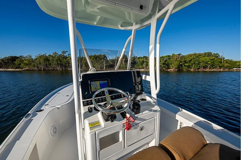 Slide: The Image of 2019 Sea Hunt BX 22 BR boat dashboard with steering wheel and navigation system. - 18