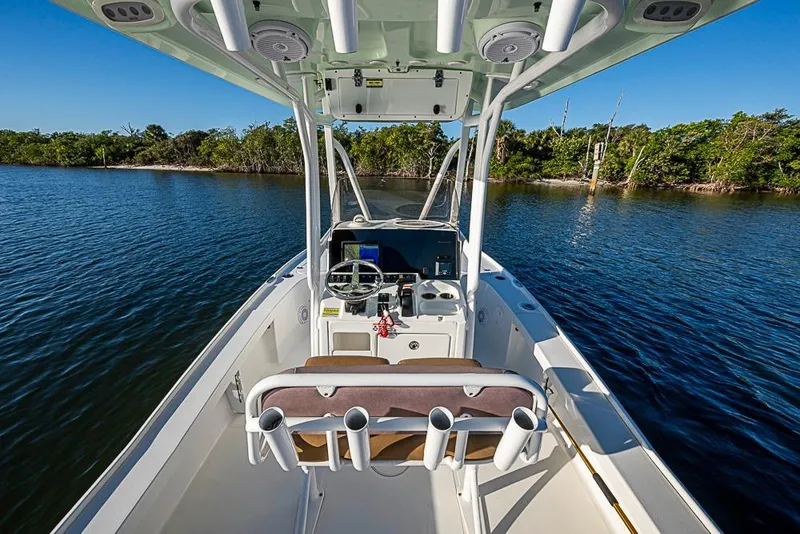 Slide: The Image of 2019 Sea Hunt BX 22 BR boat on calm water, featuring a modern helm and rod holders. - 21