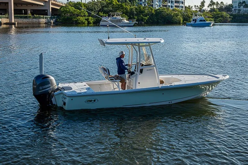 Slide: The Image of 2019 Sea Hunt BX 22 BR boat cruising on a calm river with scenic background. - 4