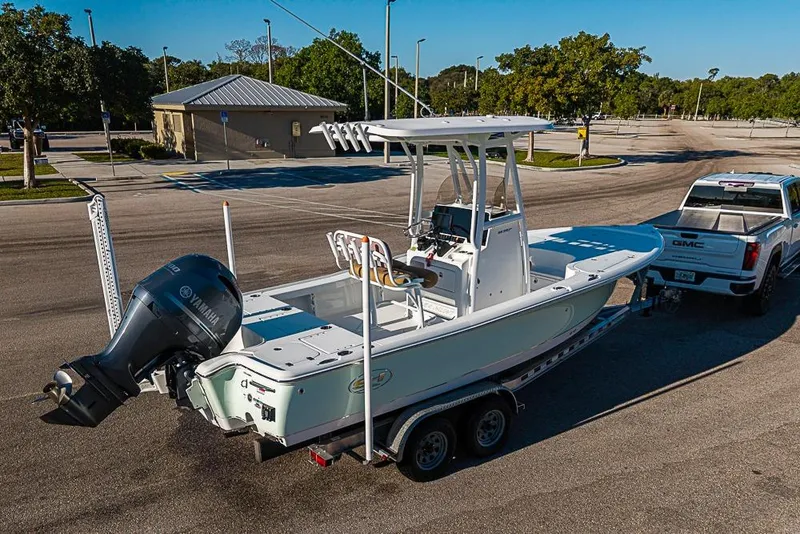 Slide: The Image of 2019 Sea Hunt BX 22 BR boat on trailer, attached to GMC truck in parking lot. - 42