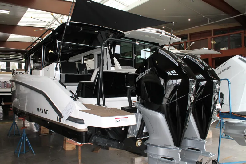 Slide: The Image of Navan C30 2026 boat with dual Mercury outboard engines in a showroom. - 11