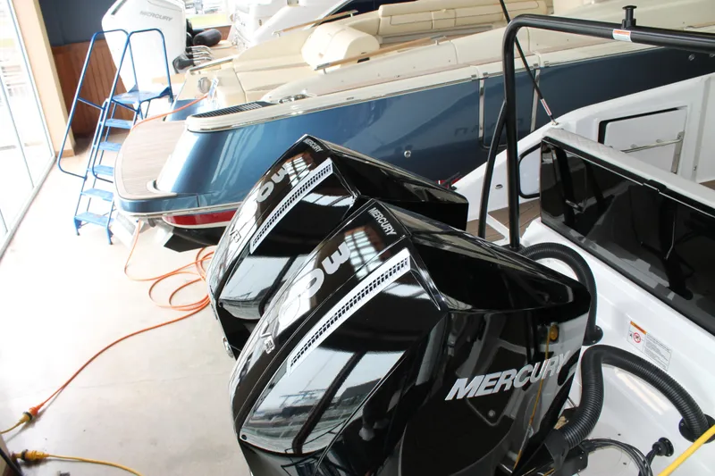 Slide: The Image of Twin Mercury outboard engines on a Navan C30 boat, 2026 model, in a showroom. - 13