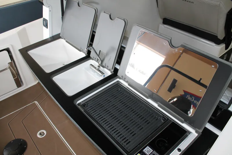 Slide: The Image of 2026 Navan C30 boat kitchen area with sink and grill setup. - 16
