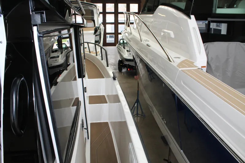 Slide: The Image of 2026 Navan C30 boats displayed in a showroom, showcasing sleek design and modern features. - 18