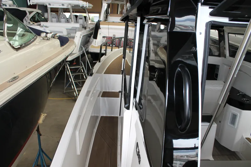 Slide: The Image of 2026 Navan C30 boat interior and exterior view in a showroom setting. - 19