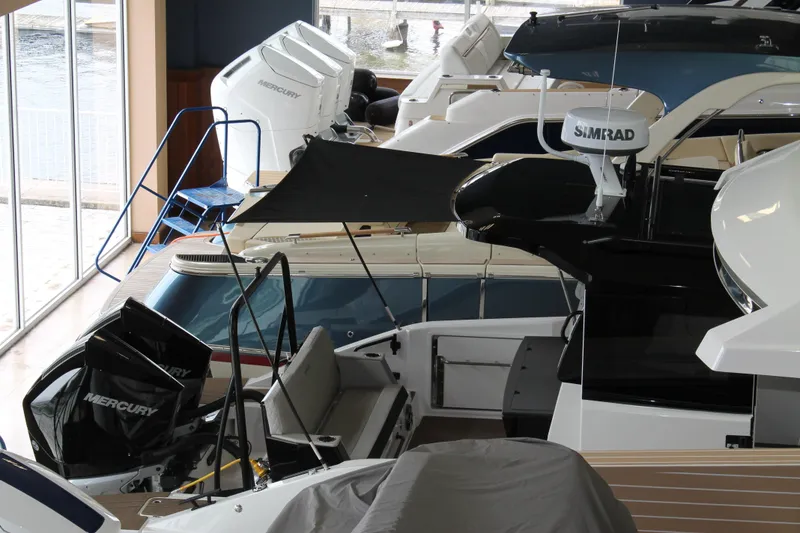 Slide: The Image of Indoor display of 2026 Navan C30 boats with Mercury engines and Simrad equipment. - 37
