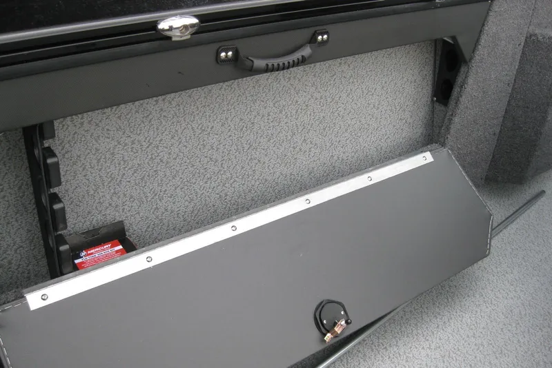 Slide: The Image of 2026 Lund 1875 Fisherman boat interior storage compartment with secure latch and textured finish. - 12