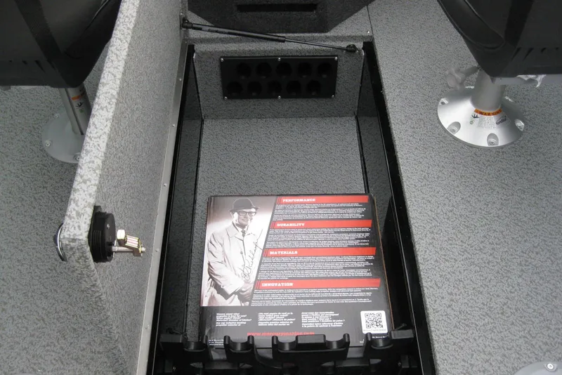 Slide: The Image of Interior storage compartment of 2026 Lund 1875 Fisherman boat with informational booklet. - 14