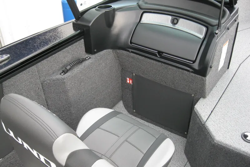 Slide: The Image of 2026 Lund 1875 Fisherman boat interior with gray seating and storage compartments. - 15