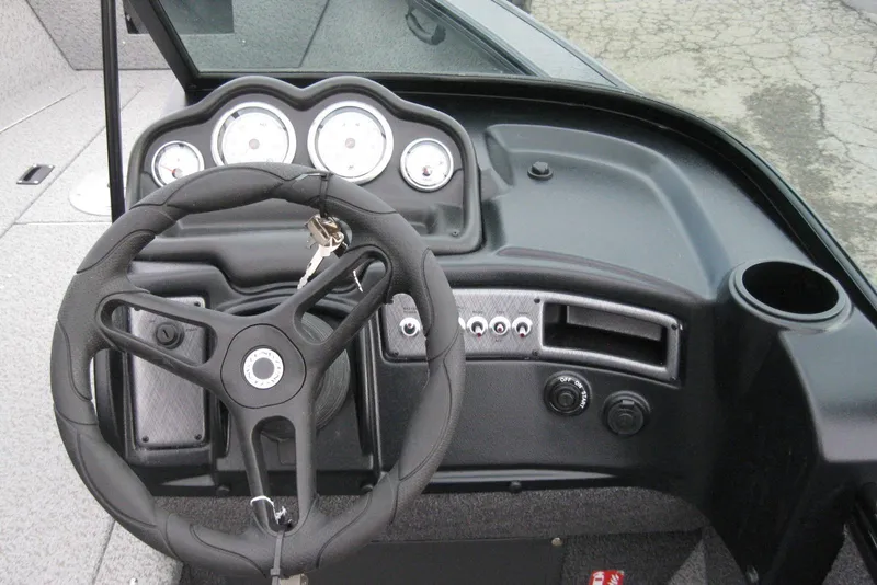 Slide: The Image of 2026 Lund 1875 Fisherman boat dashboard with steering wheel and instrument panel. - 17