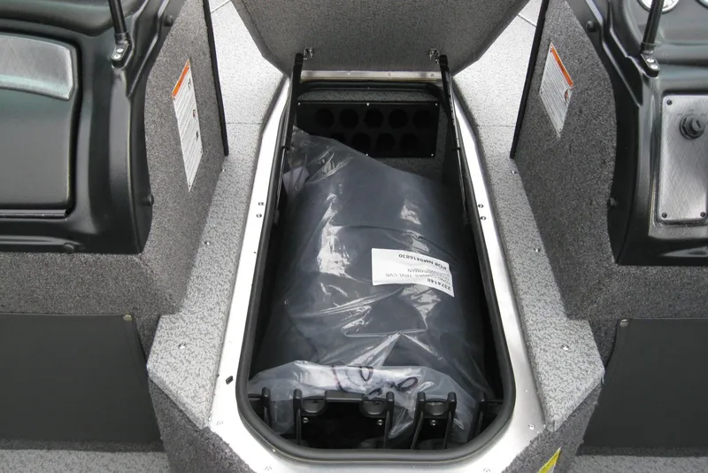 Slide: The Image of 2026 Lund 1875 Fisherman boat storage compartment with protective cover inside. - 19
