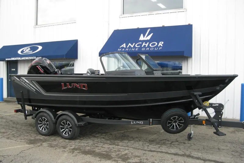 Slide: The Image of 2026 Lund 1875 Fisherman boat on trailer outside Anchor Marine Group. - 2