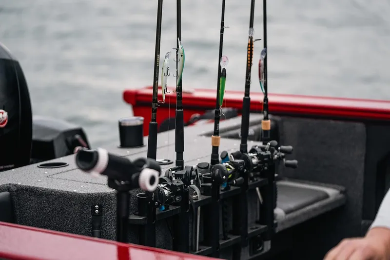 Slide: The Image of Manufacturer Provided Image: Fishing rods on a 2025 Lund 1875 Fisherman boat by the water. - 22
