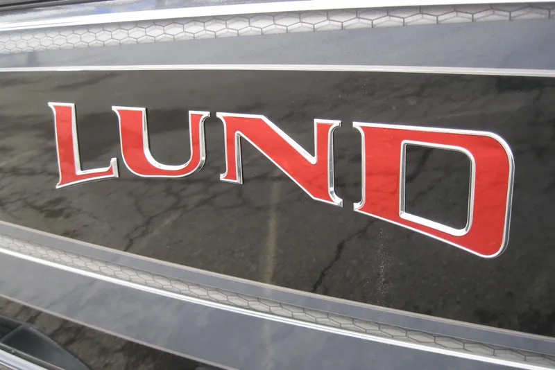Slide: The Image of Lund 1875 Fisherman 2026 boat logo in bold red lettering. - 3