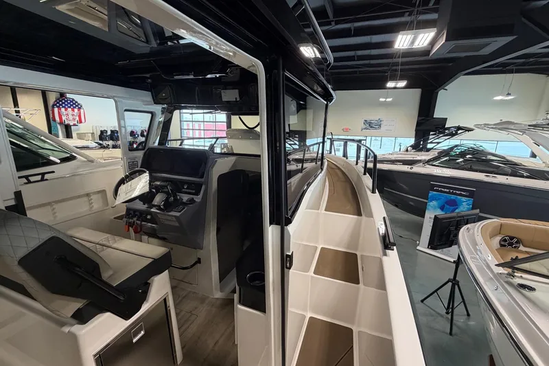 Slide: The Image of Interior view of 2026 Navan C30 boat in showroom, showcasing helm and seating area. - 17