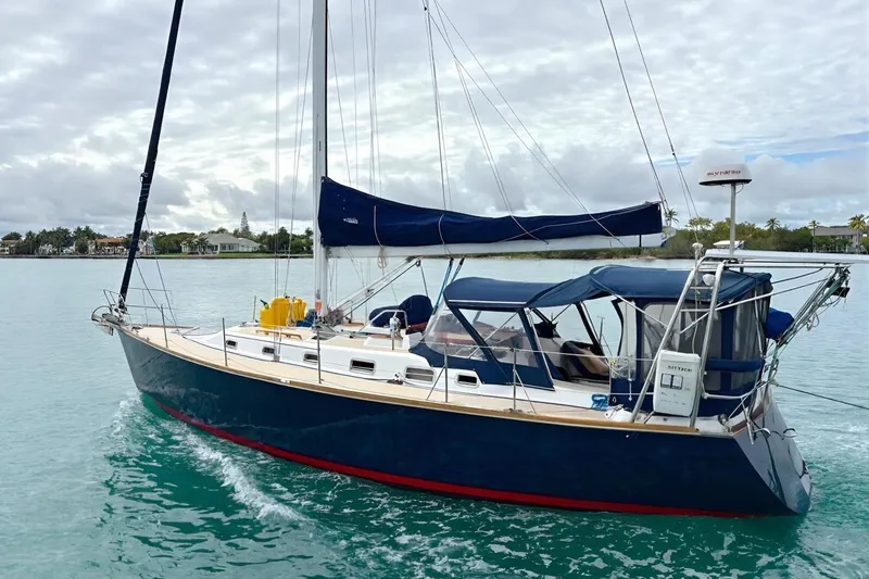 The Image of Sailing yacht Tartan 3700, 2001 model, cruising on calm waters under a cloudy sky. - 0