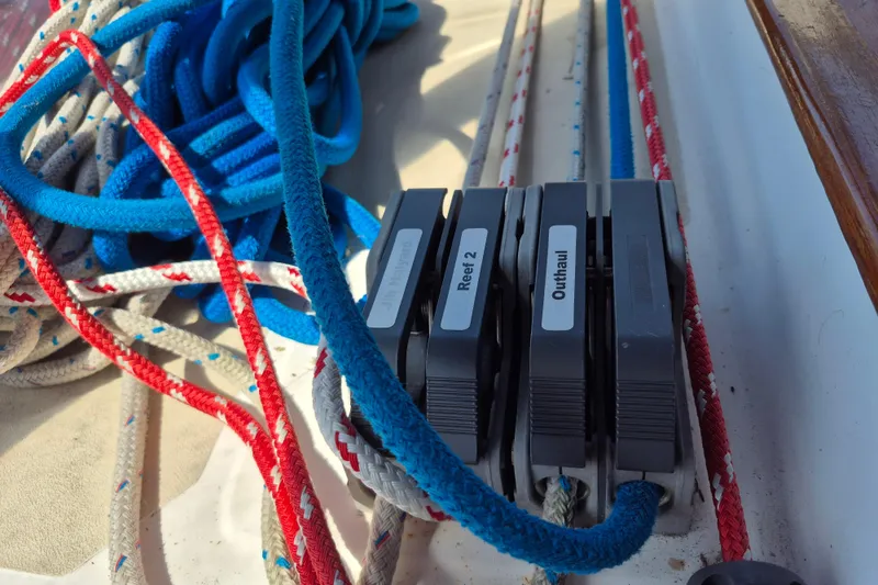 Slide: The Image of Sailboat rigging with labeled clutches and colorful ropes on a 2001 Tartan 3700. - 12