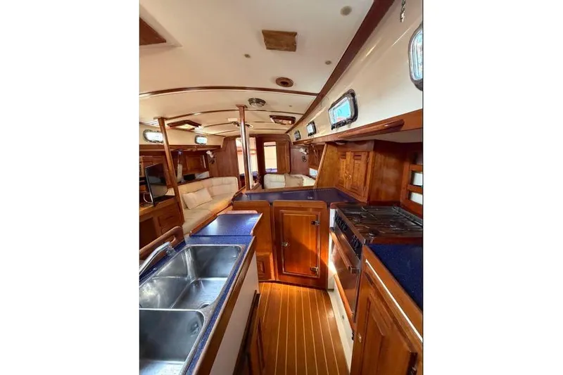 Slide: The Image of Interior of 2001 Tartan 3700 yacht with wooden cabinetry and modern amenities. - 20