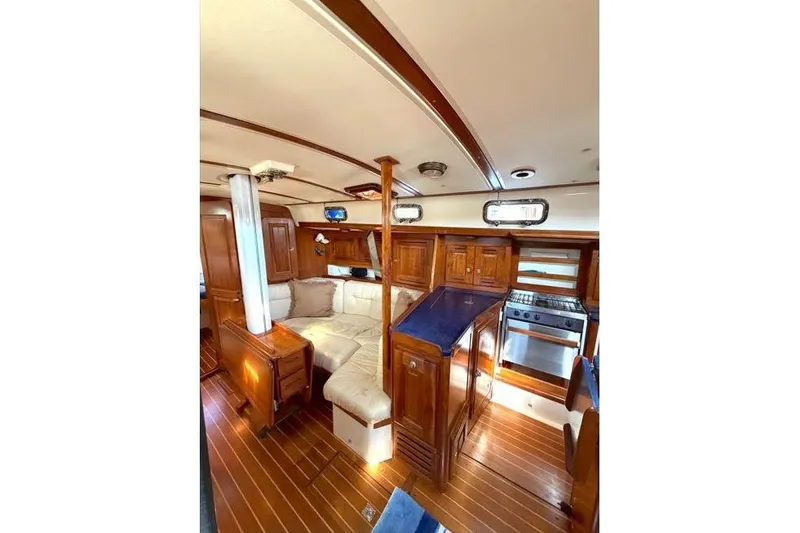 Slide: The Image of Interior of 2001 Tartan 3700 yacht with wood finish and cozy seating area. - 22
